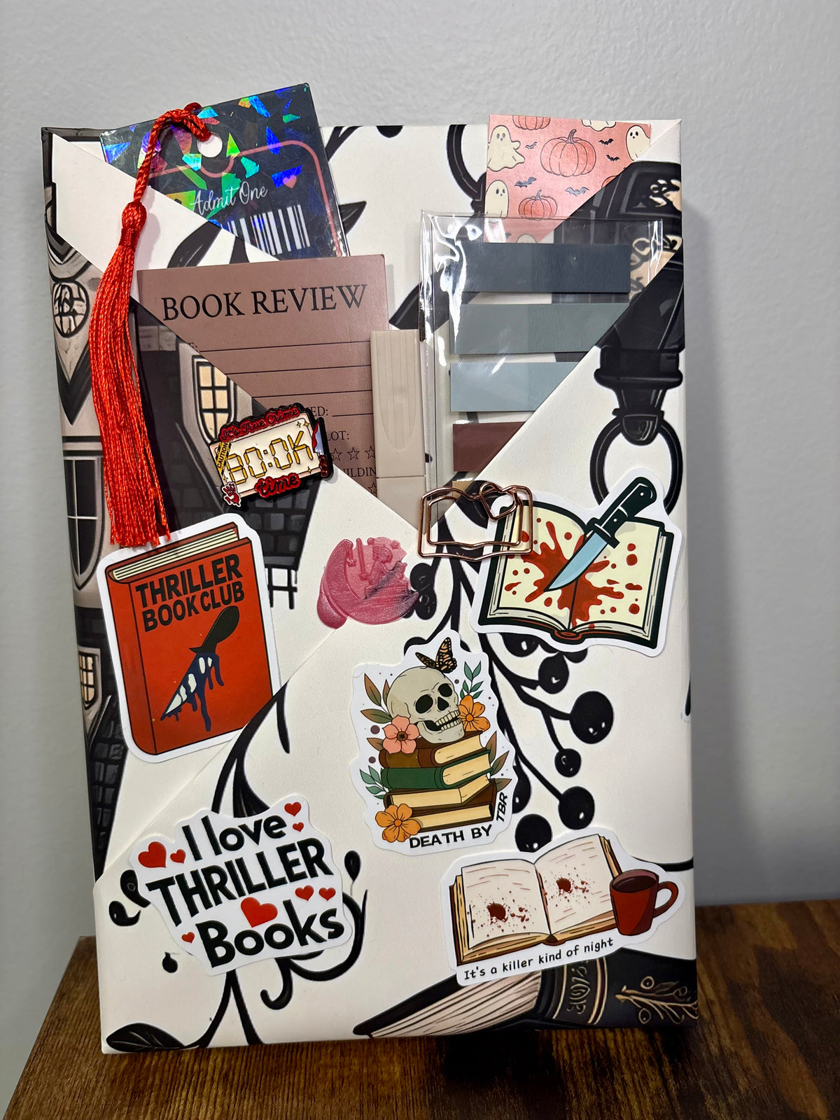 Example Blind Date with a Book hardcover kit from The Midnight Bookmark with a wrapped mystery book and bookish extras
