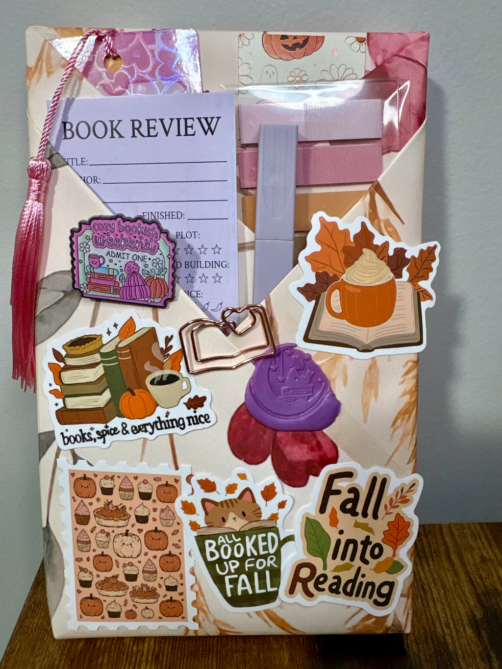 Example Blind Date with a Book paperback kit from The Midnight Bookmark with a wrapped mystery book and bookish extras