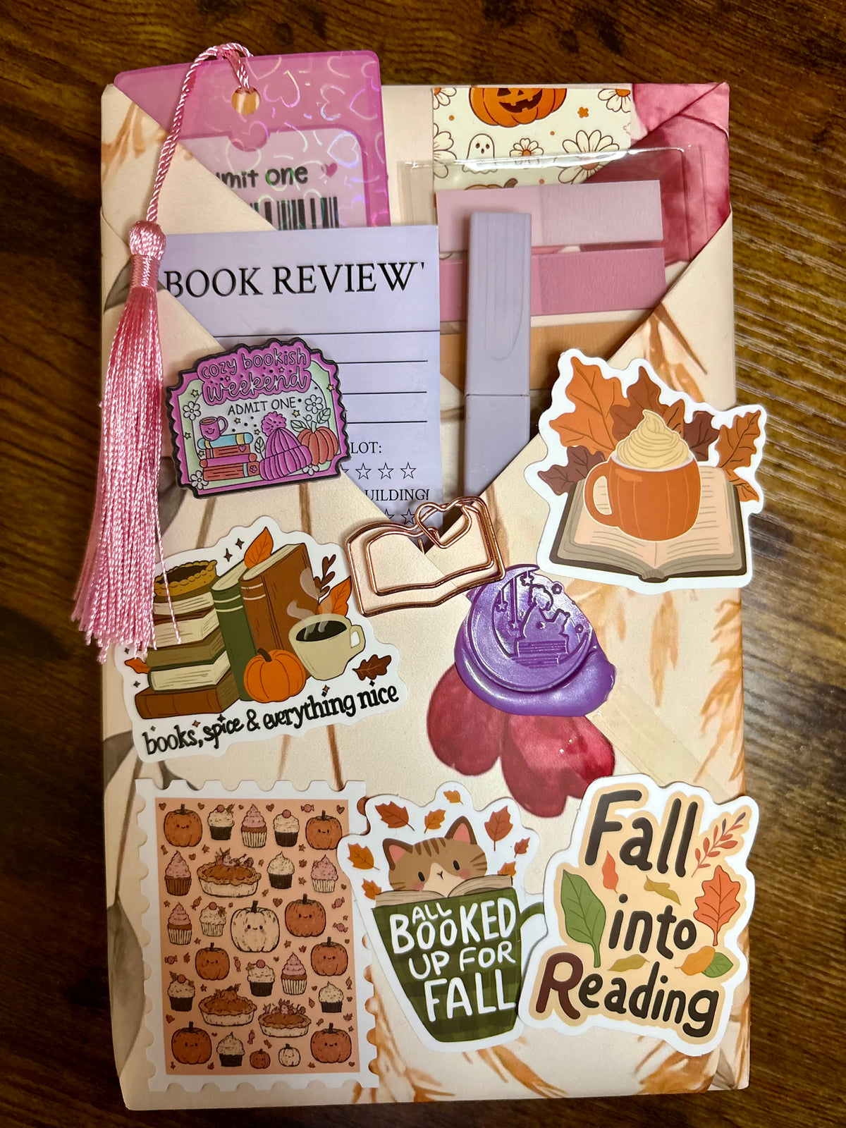 Example Blind Date with a Book paperback kit from The Midnight Bookmark featuring a wrapped mystery book and assorted bookish extras